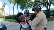 Miami Dolphins receiver Tyreek Hill is forced to the ground after being handcuffed and led to the sidewalk by Miami-Dade Police Department officers in Miami, Florida, September 8, 2024 in a still image from police body camera video. Miami-Dade Police Department/Handout via REUTERS. THIS IMAGE HAS BEEN SUPPLIED BY A THIRD PARTY
