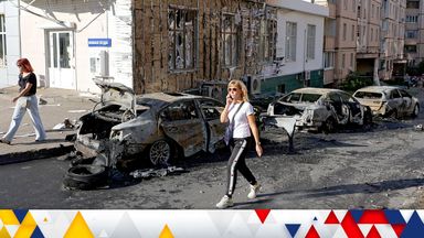 A woman walks past burnt-out cars near a residential building after shelling, which local authorities called a Ukrainian military strike, in the course of Russia-Ukraine conflict in Belgorod, Russia September 16, 2024. REUTERS/Stringer