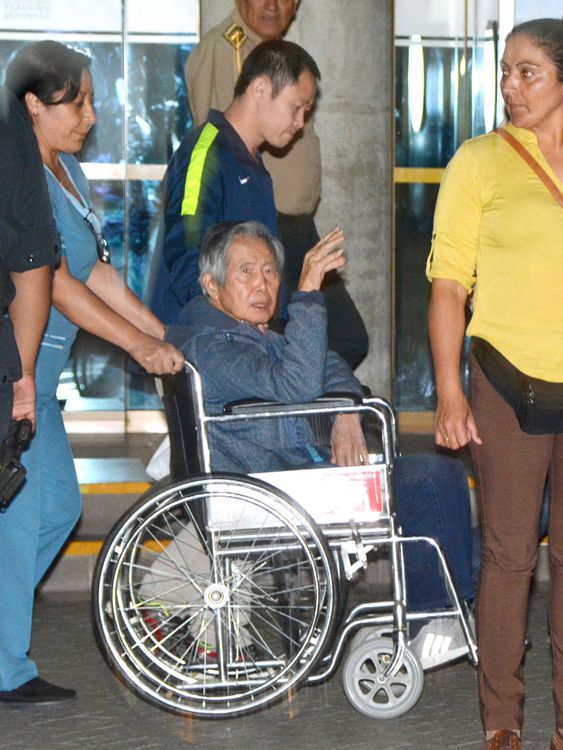 Fujimori waves from a wheelchair as he is released from a hospital in Lima in January 2018. Pic: Kyodo via AP