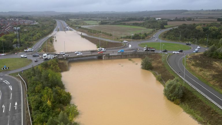 The open boot of a car is seen above the water where the vehicle became submerged in floodwaters on the A421 in Marston Moretaine, Bedfordshire. Parts of the UK have been hit by flash flooding after some areas received more rain in 24 hours than they normally receive in a month. Heavy rainfall has flooded parts of Northamptonshire, Bedfordshire and London, causing widespread traffic disruption and property damage. Date taken: Monday 23 September 2024.