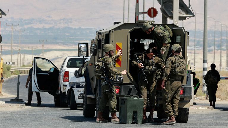 Israeli soldiers pictured at the crossing after the three men were killed. Pic: Reuters