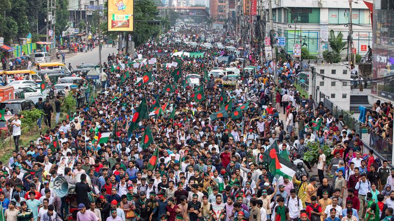 Students and other activists carry Bangladesh's national flag during a protest march organized by Students Against Discrimination to mark one month since former Prime Minister Sheikh Hasina stepped down after a mass uprising, in Dhaka, Bangladesh, Thursday, Sept. 5, 2024. (AP Photo/Rajib Dhar)