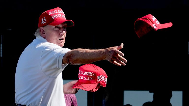 Donald Trump throws autographed hats to the crowd during the final round of the Bedminster Invitational LIV Golf tournament in Bedminster.
Pic: AP