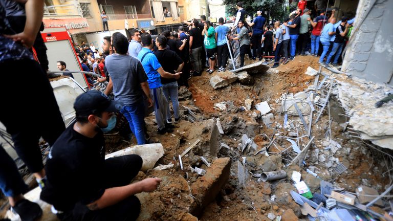 Lebanese gather near a crater caused by an Israeli air raid attack in Beirut southern suburb. Israel carried out an attack in the Lebanese capital, targeting a senior Hezbollah commander, killing 12 people and wounding 66. Photo by: Stringer/picture-alliance/dpa/AP Images