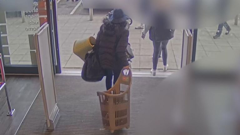 Woman seen leaving a department store loaded up with bags, having not paid for any of the items in them