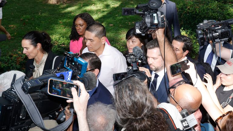 Linda Sun (centre background) and husband Chris Hu leaving Brooklyn Federal Court. Pic: AP