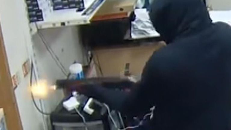 CCTV shows men attacking a computer shop with shotguns