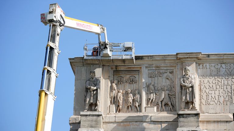 Workers on site with cranes gather up fragments and secure broken areas of the 315 A.D Arch of Constantine, near the Colosseum, in Rome, Wednesday, Sept. 4, 2024, after lightning struck it during a storm Tuesday, Sept. 3, loosening fragments from the ancient Roman structure. (AP Photo/Andrew Medichini)