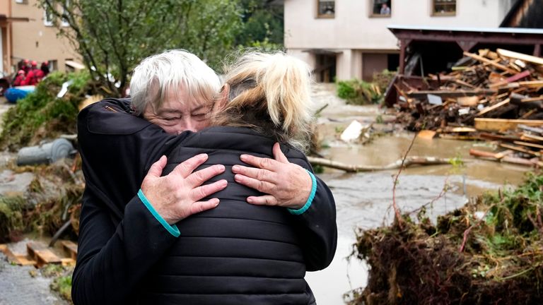 A resident hugs with her relative after being evacuated from her flooded house in Jesenik, Czech Republic, Sunday, Sept. 15, 2024. (AP Photo/Petr David Josek)