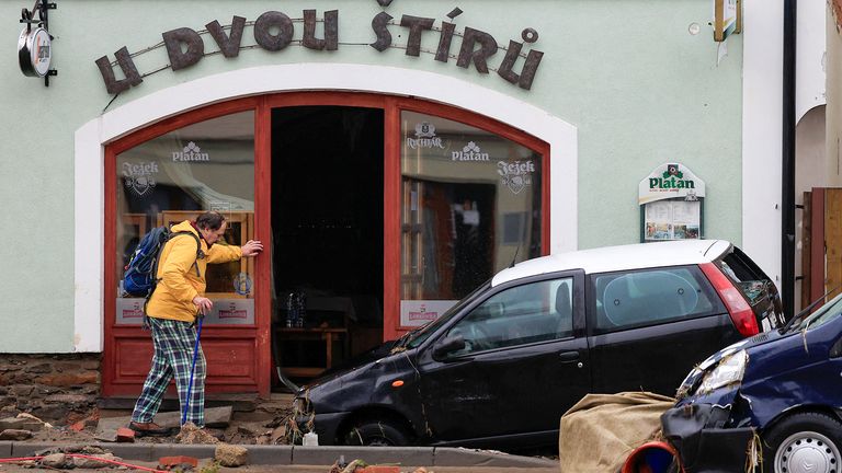 A man walks next to a damaged cars following flooding  in Jesenik, Czech Republic.
Pic: Reuters