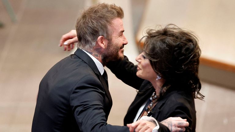 David Beckham greets Nancy Dell'Olio inside the church. Pic: Reuters