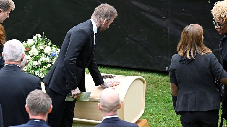 David Beckham touches Eriksson's coffin at the wake in Torsby. Pic: AP