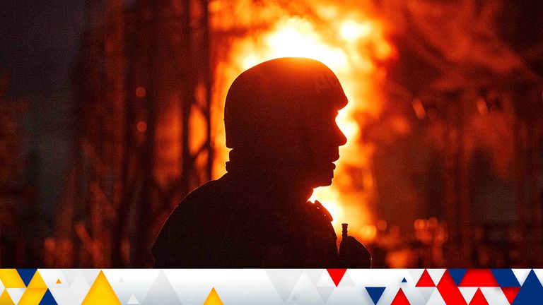 A rescue worker looks on at a fire of a burning electrical substation hit by a Russian bombing in Dnipropetrovsk region, Ukraine, Monday, Sept. 2, 2024. (AP Photo/Evgeniy Maloletka)