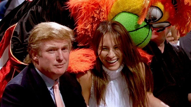 Real estate developer and Reform Party presidential hopeful Donald Trump sits with model Melania Knauss before the Miami Heat-Washington Wizards game  in 1999
Pic: Miami Herald/AP