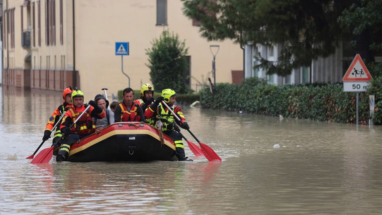 Firefighters use a dingy boat to evacuate civilians after flooding in Faenza, in the region of Emilia Romagna, Italy, Thursday, Sept. 19, 2024. (Fabrizio Zani/LaPresse via AP)