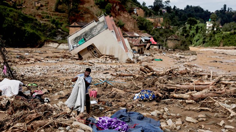 A man retrieves goods from a house swept by flood following heavy rainfall along the bank of Roshi River at Panauti in Kavre, Nepal September 30, 2024. REUTERS/Navesh Chitrakar 