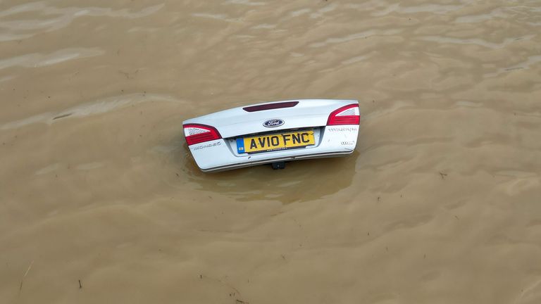 The open boot of a car is visible above the water where the vehicle is submerged in flood water on a421 in Marston Moretaine, Bedfordshire. Parts of Britain have been struck by flash floods after some areas saw more than a month's worth of rain in 24 hours. Heavy rainfall has seen parts of Northamptonshire, Bedfordshire and London submerged causing widespread travel disruption and damage to properties. Picture date: Monday September 23, 2024.
