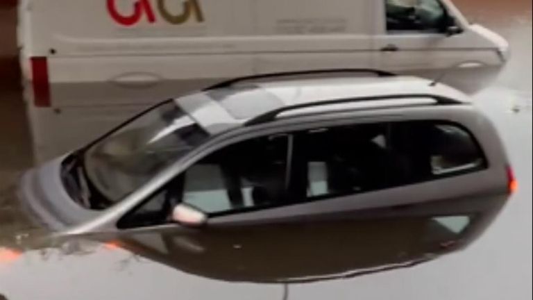 Vehicles are partially submerged by floodwater in Bedfordshire