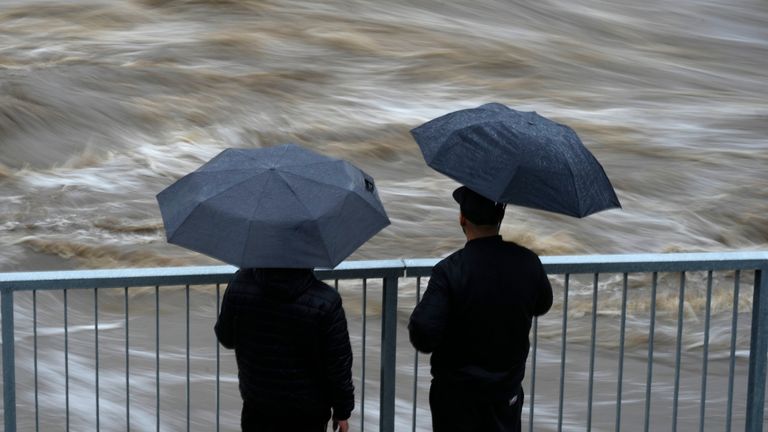 Residents watch the flow of the Bela River during floods in  Czech Republic. Pic: AP