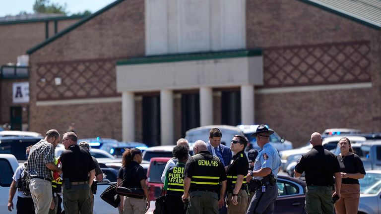 Police in front of the school after the attack. Image: AP