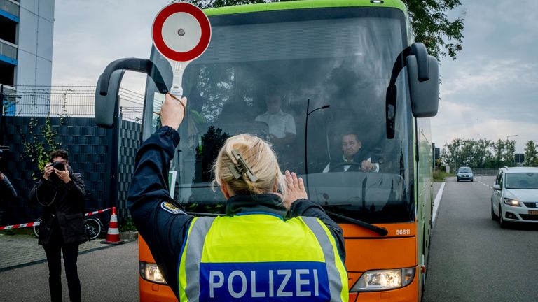 A German police officer stops a bus at the border between Germany and France in Kehl, Germany.
Pic: AP