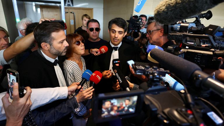 Gisele Pelicot, who has allegedly been drugged and raped by men solicited by her husband Dominique Pelicot, stands next to her lawyers Stephane Babonneau and Antoine Camus, at the courthouse in Avignon, France, September 10, 2024. REUTERS/Manon Cruz