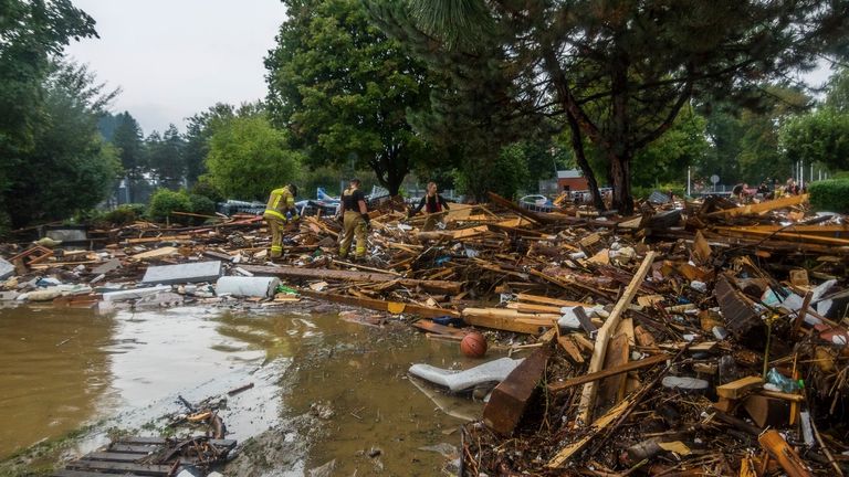 This handout photo provided by the Polish fire department, shows firefighters removing piles of debris dumped in the streets by high flood wave that is passing through southwestern Poland, in Glucholazy, Poland, on Tuesday, Sept. 17, 2024. ( Marcin Muskala/KG PSP via AP)