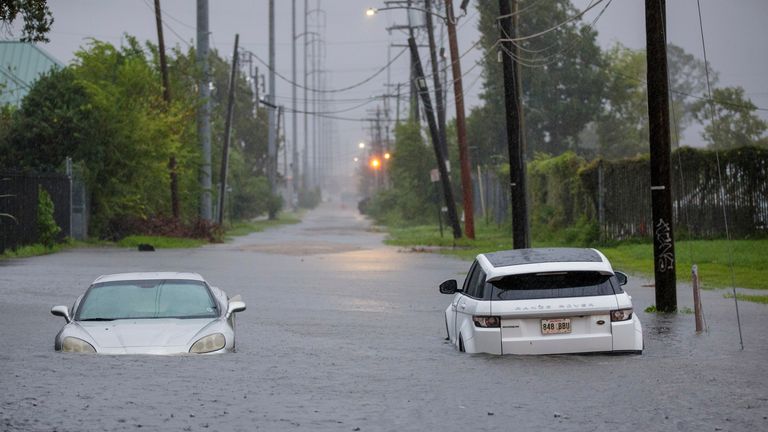 Two vehicles on Olive Street are flooded during Hurricane Francine in New Orleans, Wednesday, Sept. 11, 2024. (David Grunfeld/The Times-Picayune via AP)