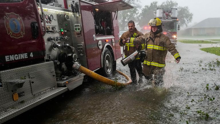 Morgan City firefighters respond to a home fire during Hurricane Francine in Morgan City, Louisiana, on September 11, 2024. (AP Photo/Gerald Herbert)