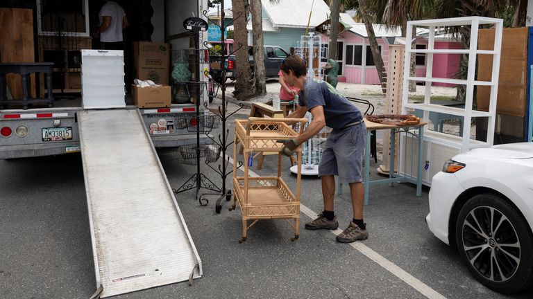 People load a truck with furniture as Hurricane Helene intensifies before its expected landfall on Florida’s Big Bend, in Cedar Key, Florida, U.S. September 25, 2024. REUTERS/Marco Bello
