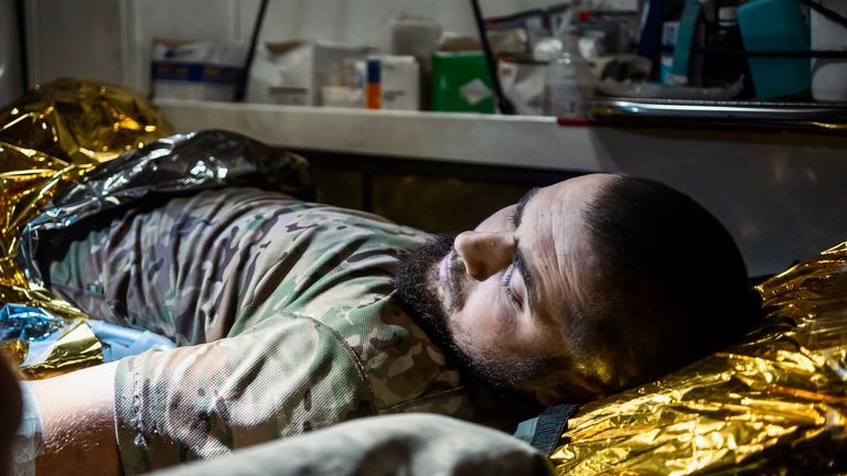 Andriy, an injured soldier, being evacuated from the frontline. Pic: Alex Rossi