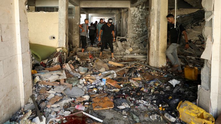 Palestinians inspect a school, which was sheltering displaced people, after it was hit by an Israeli strike, amid the Israel-Hamas conflict, in Gaza City, September 21, 2024. REUTERS/Dawoud Abu Alkas