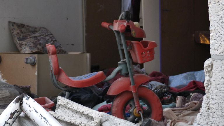 A lonely tricycle could be seen in the remains of a house 