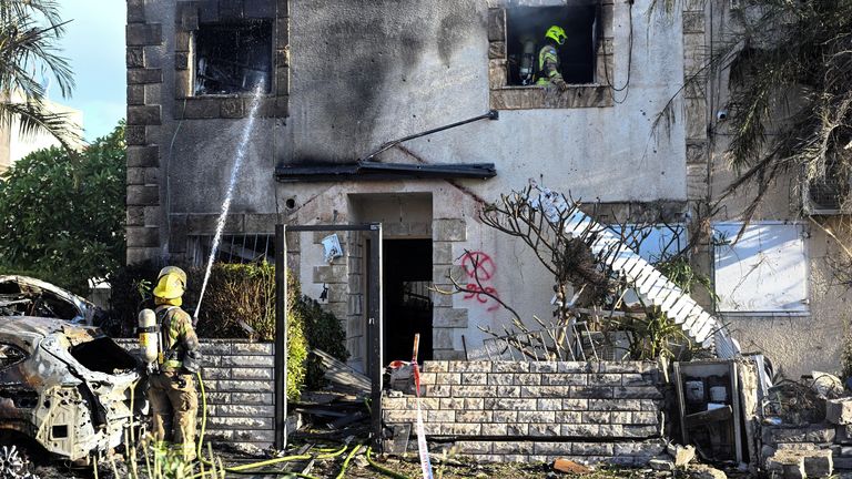 Firefighters work to put out a fire on a house that was damaged by rocket fire from Lebanon on Israel. (Pic: Reuters)