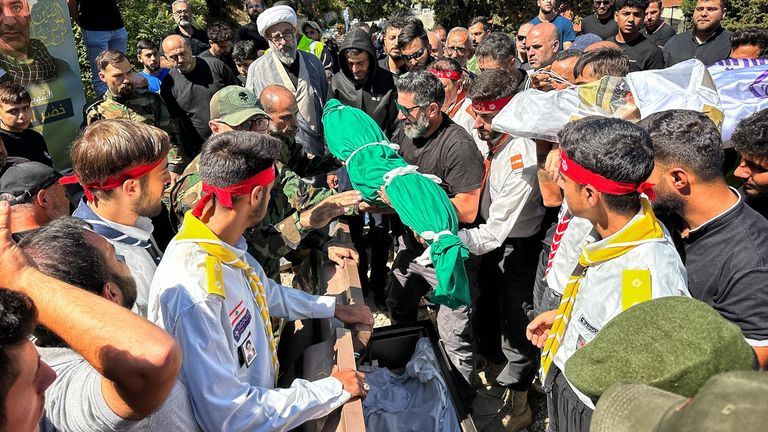 The body of the young boy Hasan being put into the ground