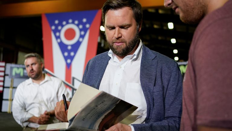 JD Vance signing his memoir for a supporter. Pic: AP