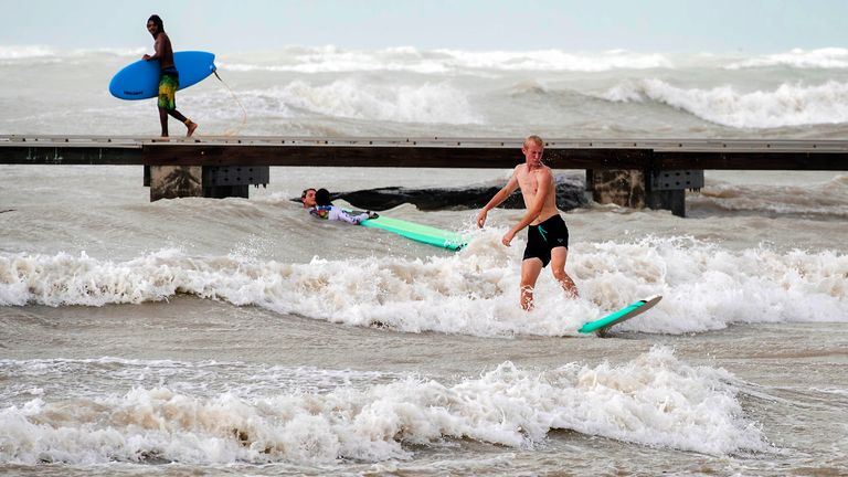 Surfers take advantage of heavy winds along Higgs Beach in Key West, Florida, on Thursday, Sept. 26, 2024. Despite passing the Florida Keys by hundreds of miles, sustained winds over 40 mph churned up the usually calm, nearshore waters. (Rob O'Neal/The Key West Citizen via AP)