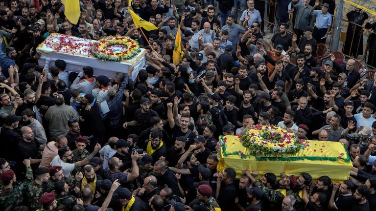 Mourners carry the coffins of victims who were killed Tuesday after their handheld pagers exploded, during their funeral procession in the southern suburb of Beirut, Lebanon, Wednesday, Sept. 18, 2024. (AP Photo/Bilal Hussein)