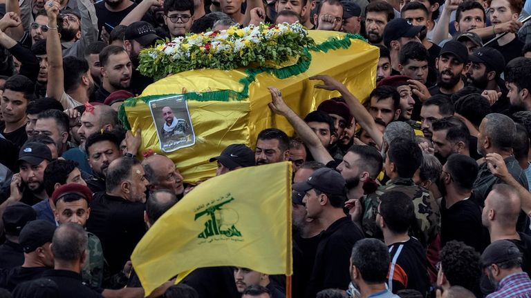 Mourners carry the coffin of Mohammed Mahdi, son of Hezbollah legislator Ali Ammar, who was killed Tuesday after his handheld pager exploded, in the southern suburb of Beirut, Lebanon, Wednesday, Sept. 18, 2024. (AP Photo/Bilal Hussein)