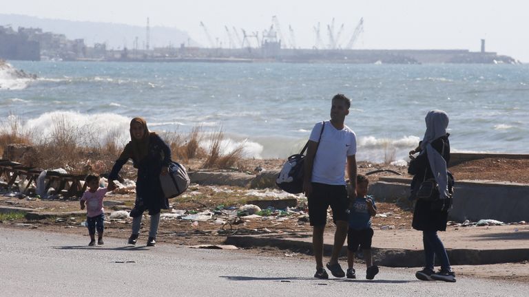 People with their belongings walk north from Lebanon's southern coastal city of Sidon as they flee Israeli bombardments, amid ongoing cross-border hostilities between Hezbollah and Israeli forces in Lebanon, September 23, 2024 REUTERS/Amr Abdallah Dalsh