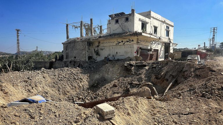 A crater on the side of a road after an Israeli airstrike on the side of the main coastal highway linking Aalma El Chaeb to Beirut