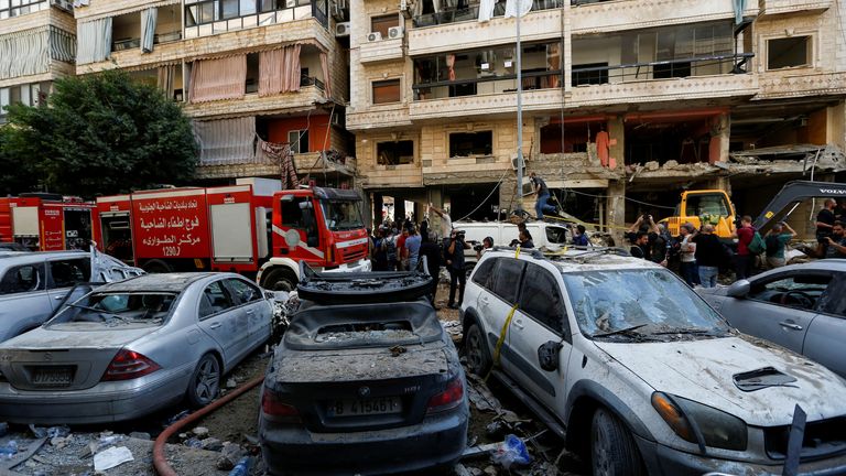 People gather near a firetruck and damaged vehicles at the site of Friday's Israeli strike, as search and rescue operations continue, in Beirut's southern suburbs, Lebanon September 21, 2024. REUTERS/Amr Abdallah Dalsh