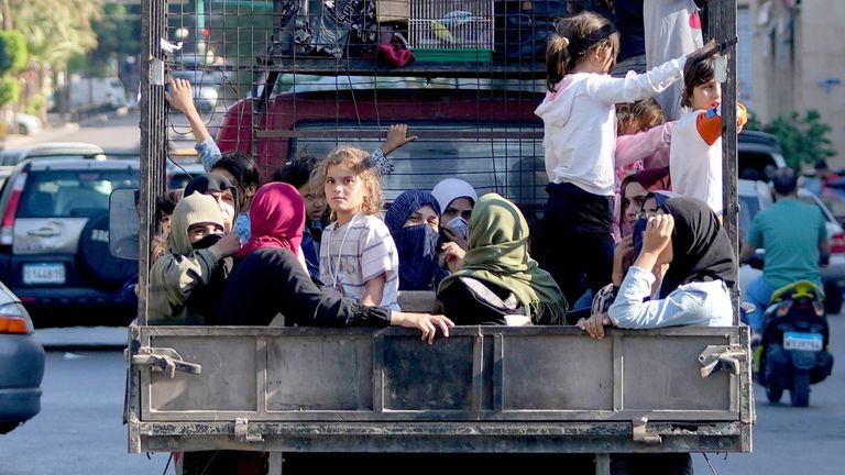 Lebanese citizens who fled from the southern villages sit in a pickup in Beirut. Pic: AP