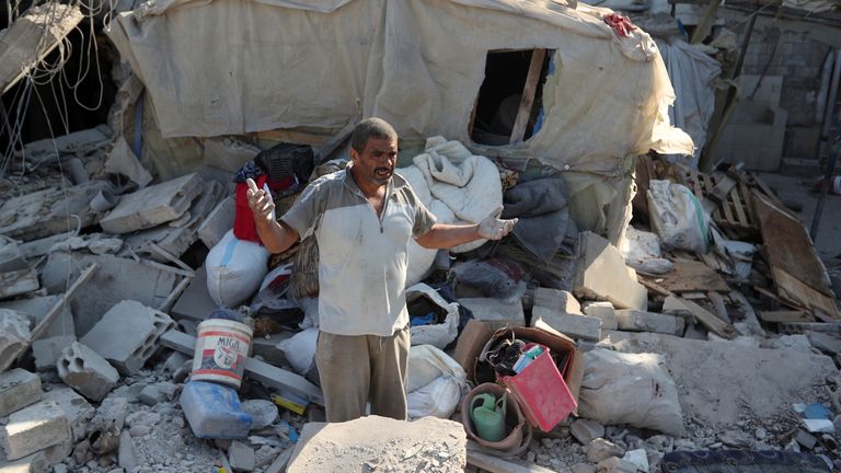 A man reacts as he stands on the rubble of a building hit in an Israeli airstrike in the southern village of Akbieh, Lebanon, Tuesday, Sept. 24, 2024. (AP Photo/Mohammed Zaatari)