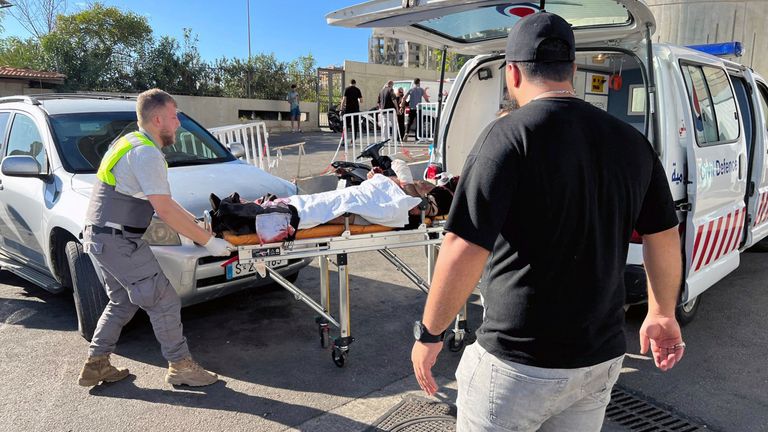 A Civil Defense first-responder carries a wounded man at al-Zahraa hospital in Beirut, Lebanon.
Pic: AP