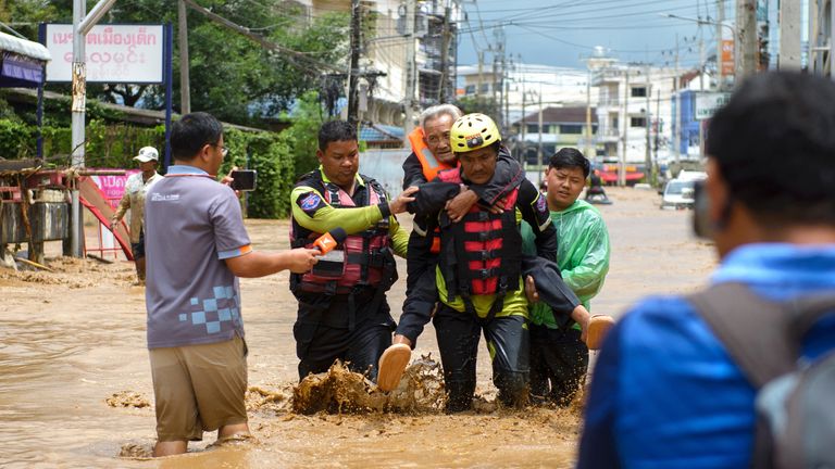 Rescue workers help stranded people from a flooded area at the border town of Mae Sai.
Pic Reuters