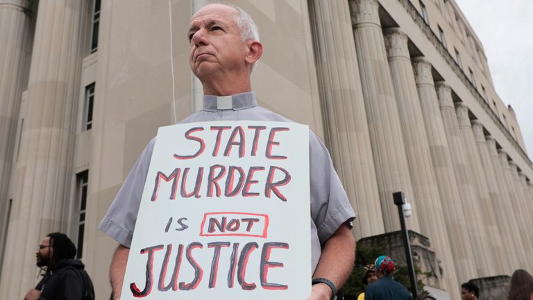 Deacon Dave Billips, with the Office of Peace and Justice with the St. Louis Archdiocese, holds a sign as he stands with protesters holding space to halt the execution of Marcellus Williams on Tuesday, Sept. 24, 2024, outside the Carnahan Courthouse in St. Louis. (Laurie Skrivan/St. Louis Post-Dispatch via AP)