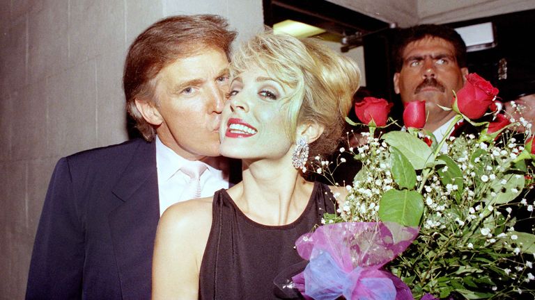 Marla Maples gets a kiss from Donald Trump at the stage door of the Palace Theater in New York following a performance of "Will Rogers Follies," Aug. 3, 1992. Maples, who plays the role of "Ziegfeld's Favorite" in the musical, took over the role in the Tony Award-winning show from Cady Huffman, who was nominated for a Tony for her part. (AP Photo/Mark Lennihan)


