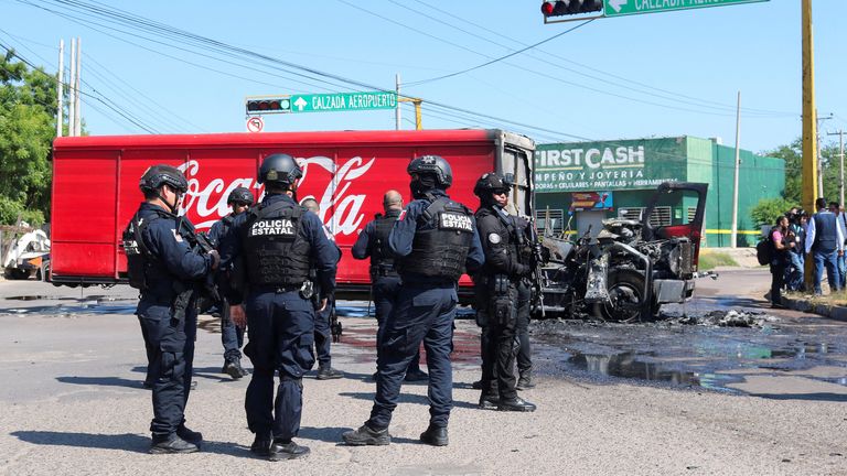 Sinaloa state police respond to the scene of a burned out truck during a wave of violence between armed groups, in Culiacan, Mexico, September 11, 2024. REUTERS/Jesus Bustamante