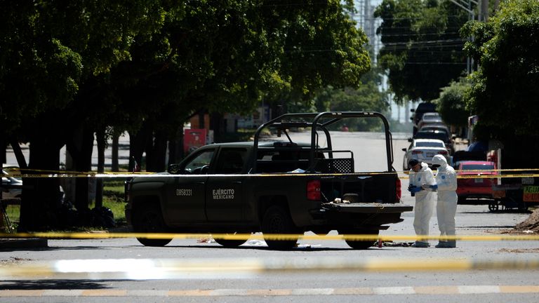 Forensics officers collect evidence at the scene of a deadly cartel battle in which a soldier was killed. Pic: Sky News